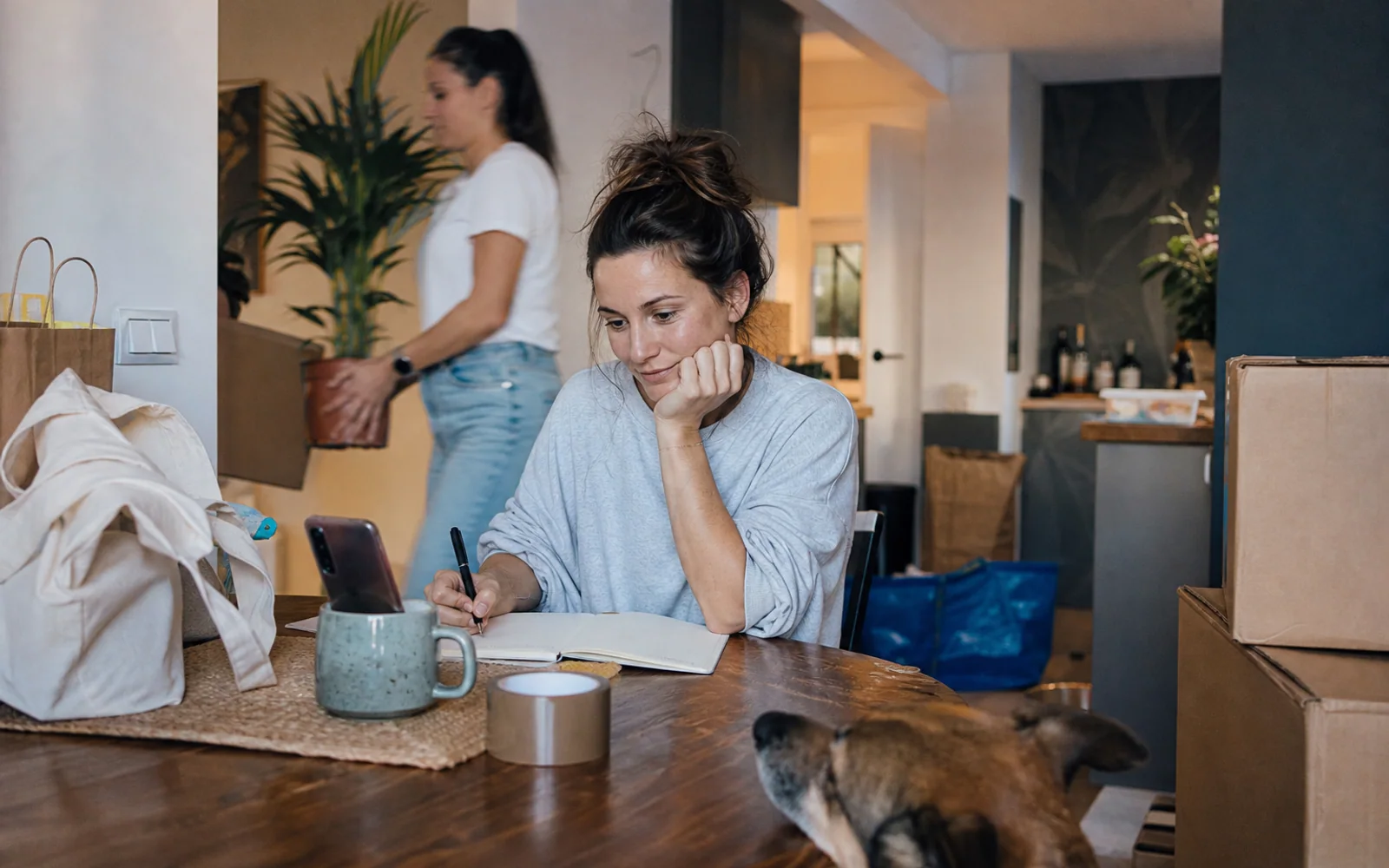 A woman takes notes during a moving consultation